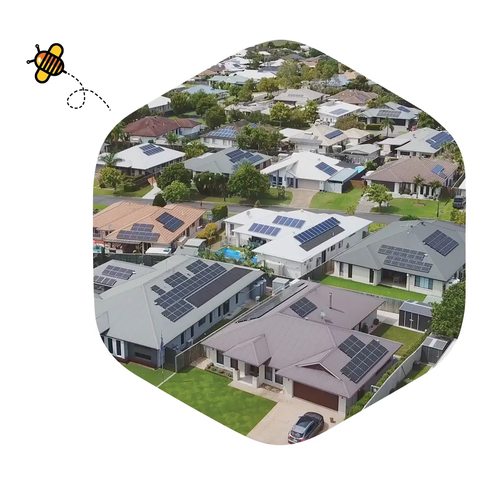Aerial view of a suburban neighbourhood with rooftop solar panels on many homes.